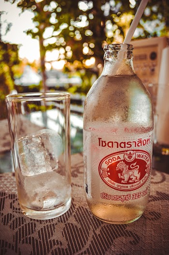 Photo of Drinking Glass Beside Bottle