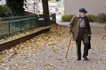 Photo of Elderly Man Walking on Pavement