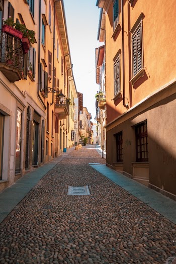 Photo of Empty Alley in Between Concrete Buildings