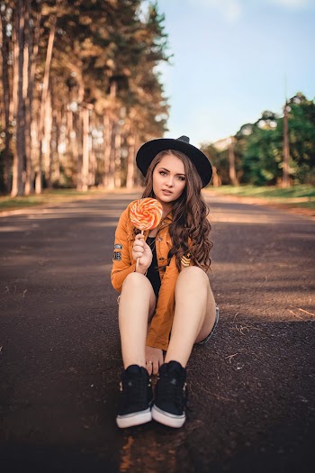 Photo of Girl Holding Lollipop