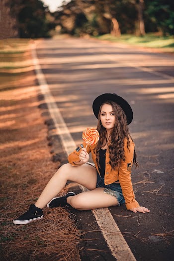 Photo of Girl Holding Lollipop