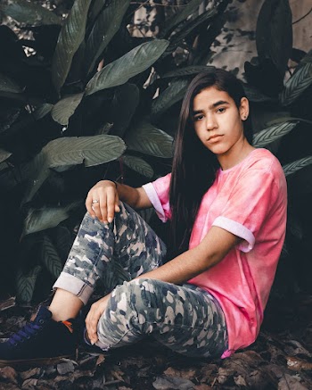 Photo Of Girl Sitting Near Plant