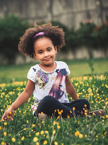 Photo of Girl Sitting On Flower Field