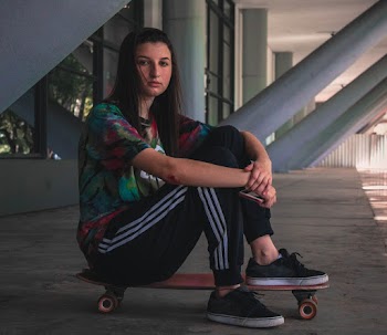 Photo of Girl Sitting on Skateboard