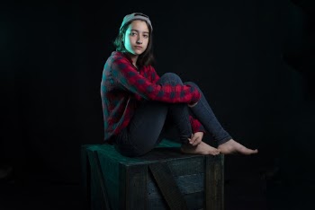 Photo of Girl Sitting On Top Of The Box