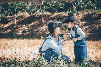 Photo of Girl Smelling Flower