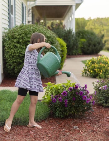 Photo of Girl Watering Flowers