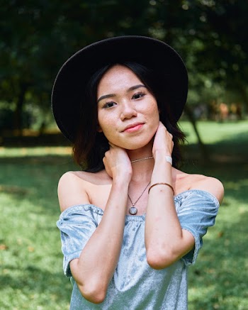 Photo of Girl Wearing Off-Shoulder Top and Black Hat