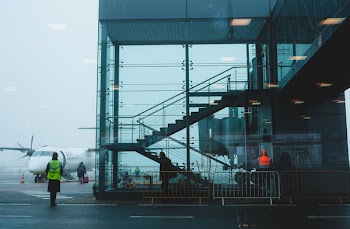 Photo of Glass Building Near Airplane