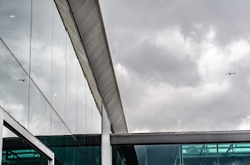 Photo of Glass Building Under Cloudy Sky