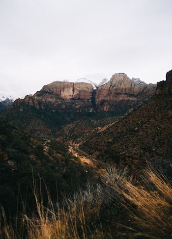 photo of gray mountains under cloudy sky