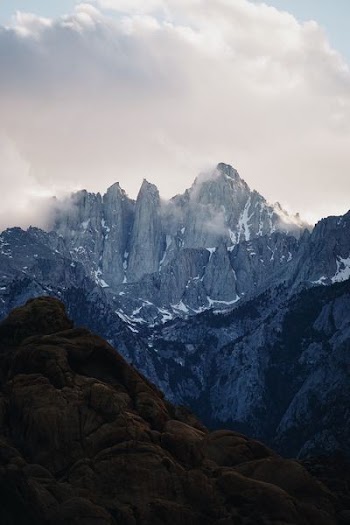 photo of gray mountains under cloudy sky