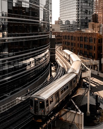 Photo of Grey Bridge Train Beside Glass Building