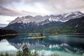 photo of grey mountain across blue lake
