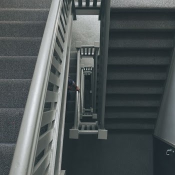 photo of grey staircase with grey metal railings