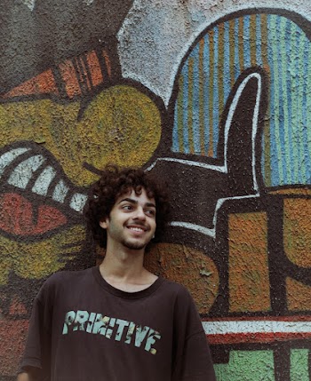 Photo of Guy Leaning On Graffiti Wall