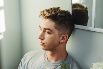 Photo of Guy Leaning On Wall