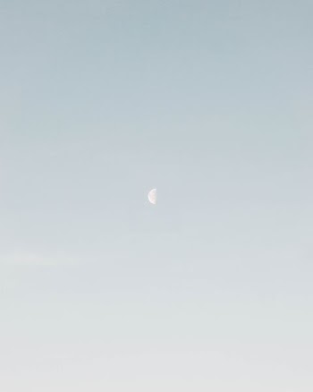photo of half-moon during daytime