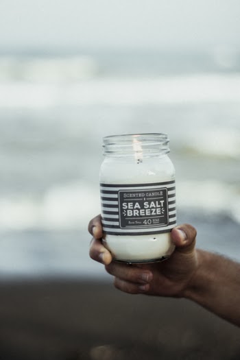 Photo of Hand Holding Sea Salt Breeze Scented Candle