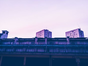 photo of high rise building under white cloud blue skies