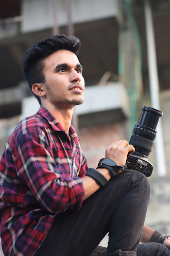 Photo of In Plaid Shirt Sitting While Holding Camera