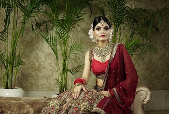 Photo of Indian Woman in traditional Saree Dress Sitting on Divan Sofa Posing