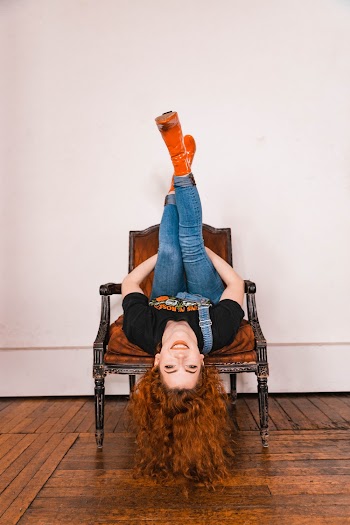 Photo of Inverted Woman on Wooden Chair