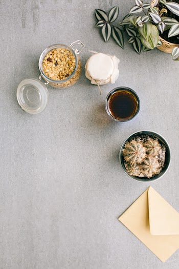 Photo of Jars Near Tea Glass and Cactus Plant
