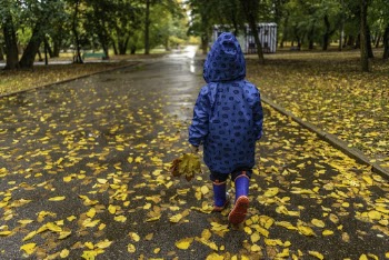 Photo of Kid Wearing Raincoat While Walking on Park