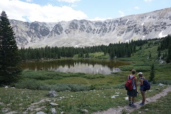 Photo of Lake Surrounded by a Snowy Mountain