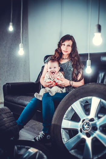 Photo of Laughing Baby Sitting on Mother's Lap