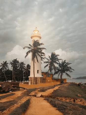 Photo of Lighthouse Near Palm Trees