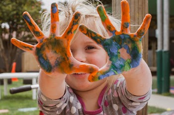 Photo of Little Girl's Hands Covered With Paint