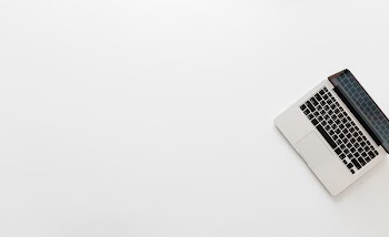 photo of MacBook Pro on white surface