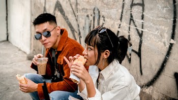 Photo of Man and Woman Eating