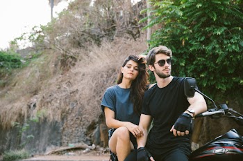 Photo of Man and Woman Sitting on Motorcycle