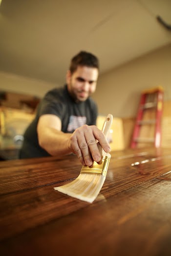 Photo of Man Applying Varnish