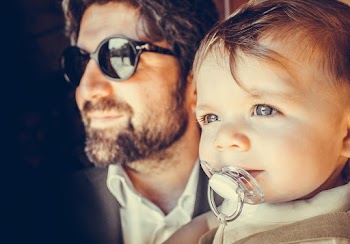 Photo of Man Carrying A Baby