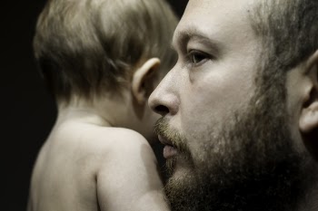Photo of Man Carrying Baby
