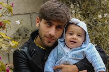 Photo of Man Carrying Baby
