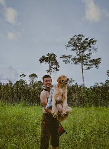 Photo Of Man Carrying Dog