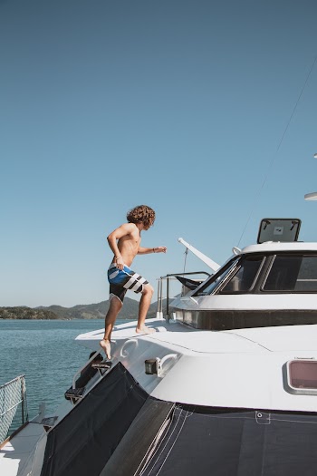 Photo of Man Climbing on Yacht