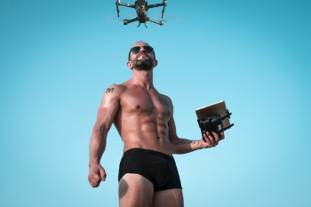 Photo of Man Controlling Black Drone