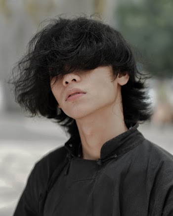 Photo of Man Covering His Eyes With His Hair