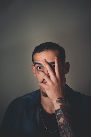 Photo Of Man Covering His Face