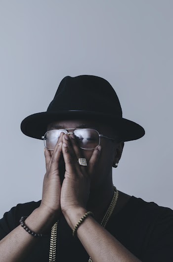 Photo of Man Covering His Face