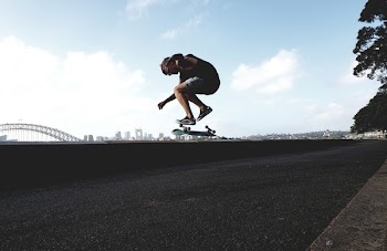 Photo of Man Doing Skateboard Trick