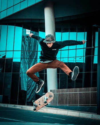 Photo of Man Doing Skateboard Trick in the Street