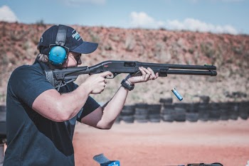 Photo of Man Firing Shotgun
