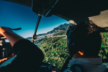 Photo of Man Flying a Helicopter